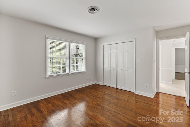 5125 Winding Brook Rd, Charlotte, NC 28226 - unfurnished bedroom featuring wood finished floors, a closet, baseboards, and visible vents