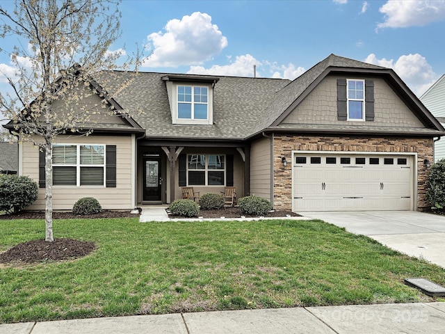 4425 Marlay Park, Indian Trail, NC 28079 - view of front of house featuring concrete driveway, a front yard, roof with shingles, stone siding, and covered porch