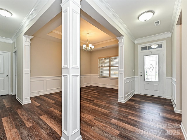 4425 Marlay Park, Indian Trail, NC 28079 - foyer with decorative columns, dark wood-style floors, ornamental molding, a chandelier, and wainscoting