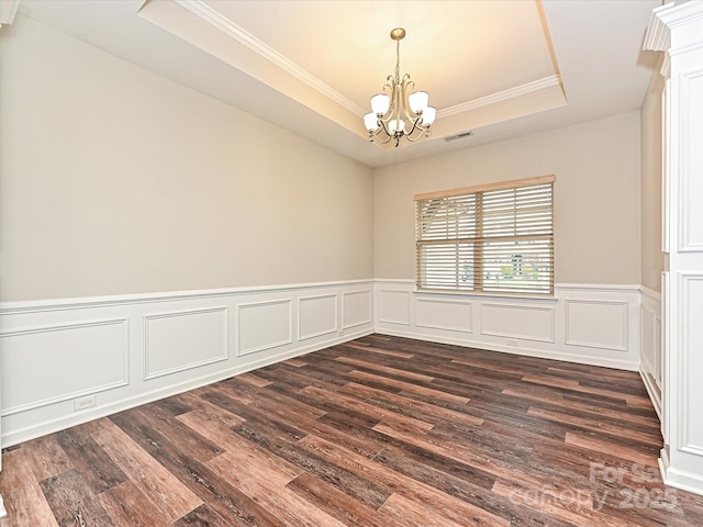 4425 Marlay Park, Indian Trail, NC 28079 - empty room with a tray ceiling, a chandelier, dark wood finished floors, crown molding, and wainscoting