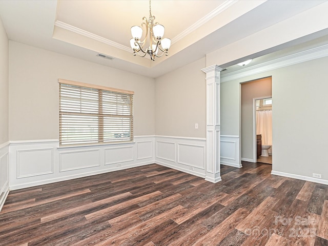 4425 Marlay Park, Indian Trail, NC 28079 - empty room with crown molding, dark wood-type flooring, a chandelier, ornate columns, and a wainscoted wall