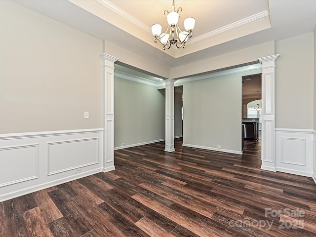 4425 Marlay Park, Indian Trail, NC 28079 - empty room featuring ornate columns, a chandelier, dark wood-type flooring, ornamental molding, and a wainscoted wall