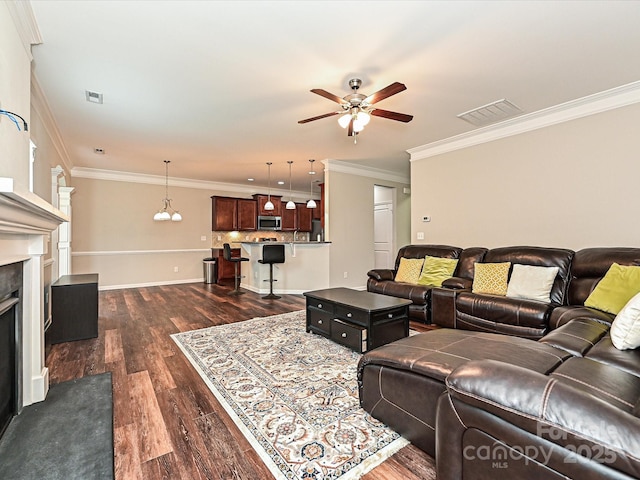 4425 Marlay Park, Indian Trail, NC 28079 - living area with a ceiling fan, dark wood-type flooring, ornamental molding, a fireplace, and baseboards