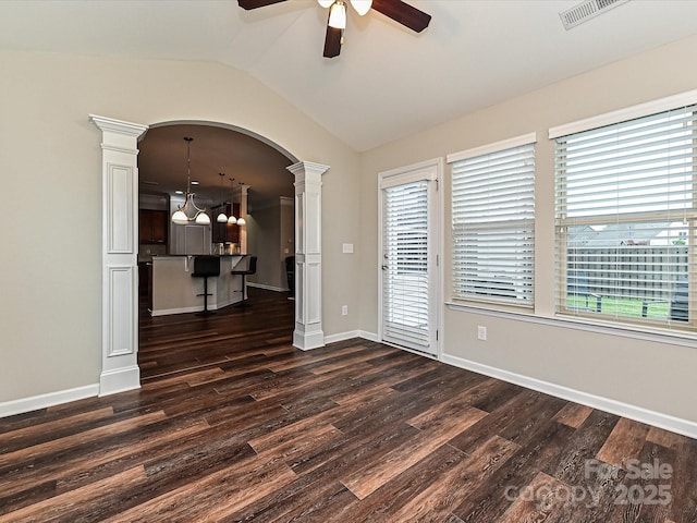 4425 Marlay Park, Indian Trail, NC 28079 - unfurnished room featuring decorative columns, a ceiling fan, dark wood-style flooring, healthy amount of natural light, and lofted ceiling
