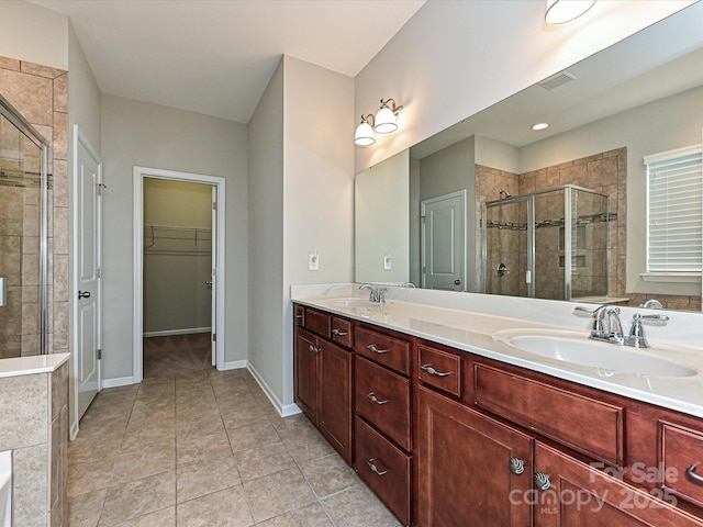 4425 Marlay Park, Indian Trail, NC 28079 - bathroom featuring a stall shower, double vanity, a spacious closet, tile patterned flooring, and baseboards
