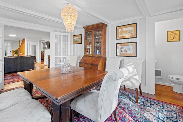 144 Miller Dr, Tryon, NC 28782 - dining space with a chandelier, crown molding, wood finished floors, and baseboards