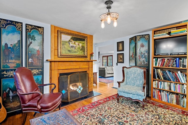 144 Miller Dr, Tryon, NC 28782 - living area with a chandelier, a fireplace, and wood finished floors