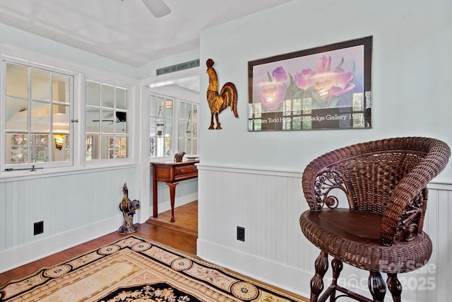 144 Miller Dr, Tryon, NC 28782 - sitting room featuring wood finished floors, ceiling fan, and a wainscoted wall
