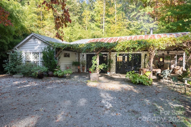 144 Miller Dr, Tryon, NC 28782 - ranch-style home featuring metal roof and a view of trees