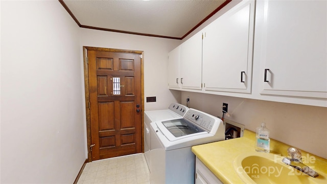 laundry room with light floors, ornamental molding, washing machine and clothes dryer, a sink, and cabinet space