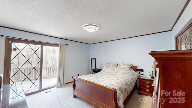 bedroom featuring access to outside, crown molding, a textured ceiling, light colored carpet, and visible vents