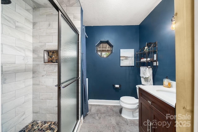 bathroom featuring toilet, a stall shower, and vanity