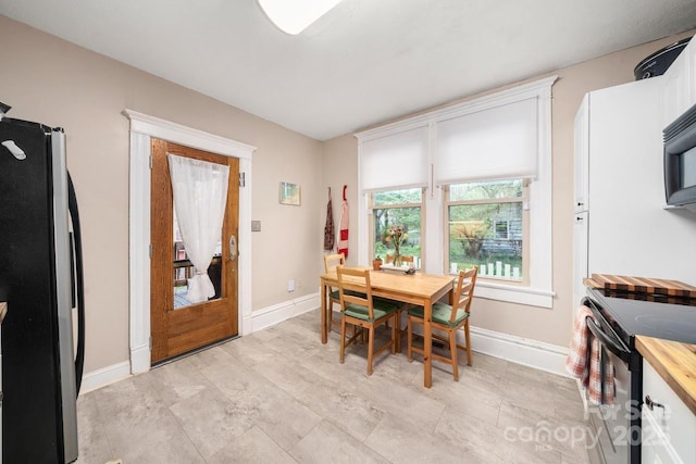 dining area featuring baseboards