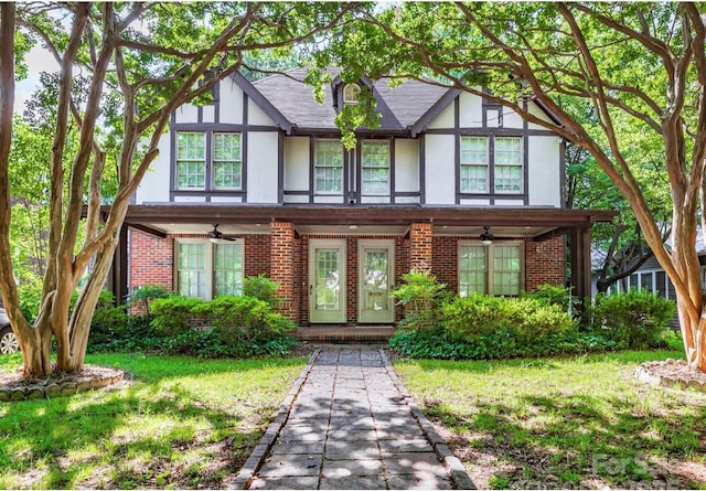 713/715 Walnut Ave, Charlotte, NC 28208 - tudor-style house featuring brick siding, a front lawn, and stucco siding