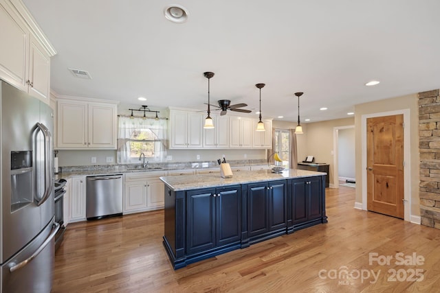 kitchen with white cabinetry, a ceiling fan, a sink, and stainless steel appliances