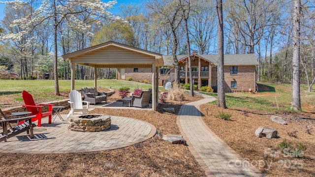 exterior space with an outdoor fire pit, a balcony, and a patio area