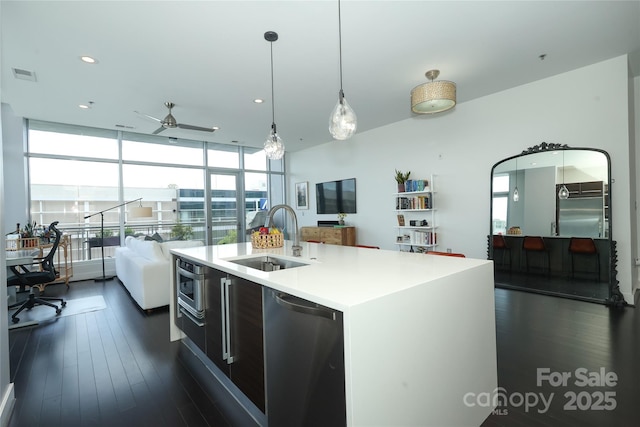 kitchen featuring stainless steel dishwasher, open floor plan, visible vents, and a sink