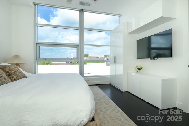 bedroom featuring dark wood-type flooring and visible vents