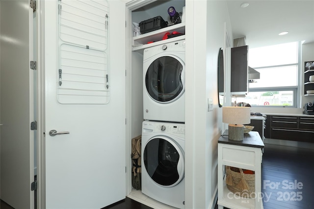 washroom with stacked washer / dryer and laundry area