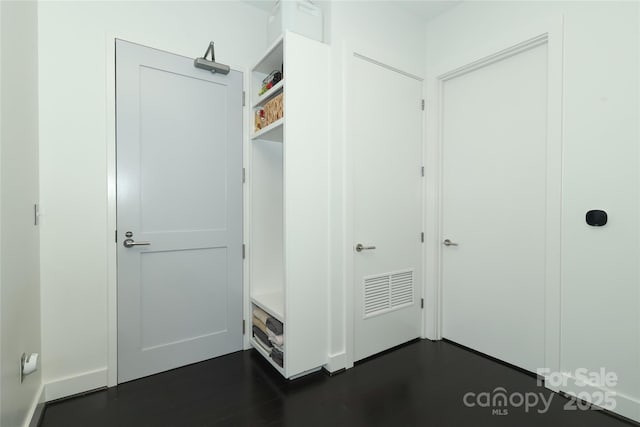 mudroom with visible vents and dark wood finished floors