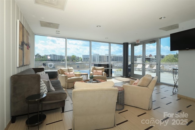 living room featuring expansive windows and a sunroom
