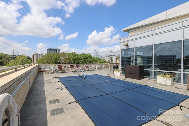 community pool featuring a patio area