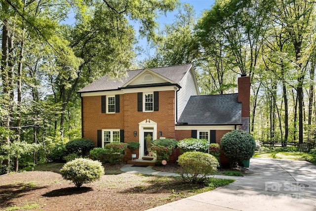 4522 Woods End Ln, Charlotte, NC 28277 - view of front facade with a chimney, brick siding, roof with shingles, and concrete driveway