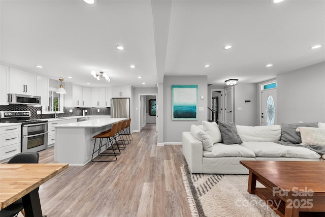 4522 Woods End Ln, Charlotte, NC 28277 - living room featuring light wood-type flooring, recessed lighting, and baseboards