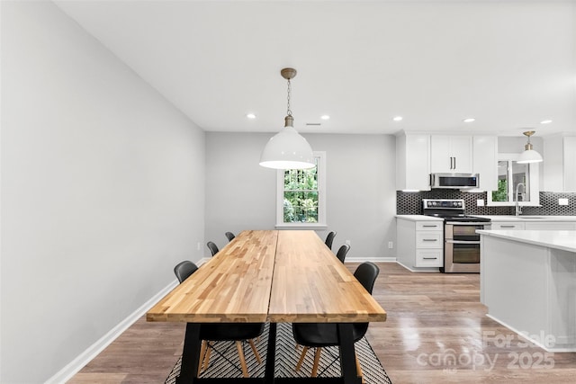 4522 Woods End Ln, Charlotte, NC 28277 - dining area with light wood-type flooring, recessed lighting, and baseboards