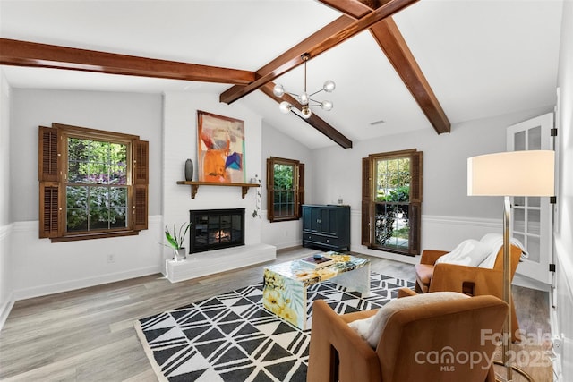 4522 Woods End Ln, Charlotte, NC 28277 - living room with wood finished floors, plenty of natural light, a chandelier, and a large fireplace