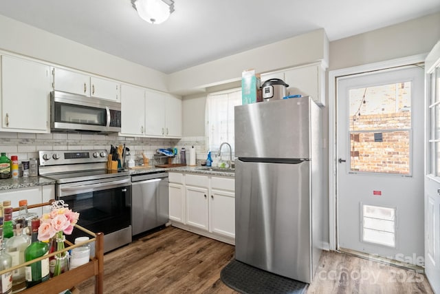 6354 Old Pineville Rd Unit F, Charlotte, NC 28217 - kitchen featuring tasteful backsplash, wood finished floors, a sink, and stainless steel appliances