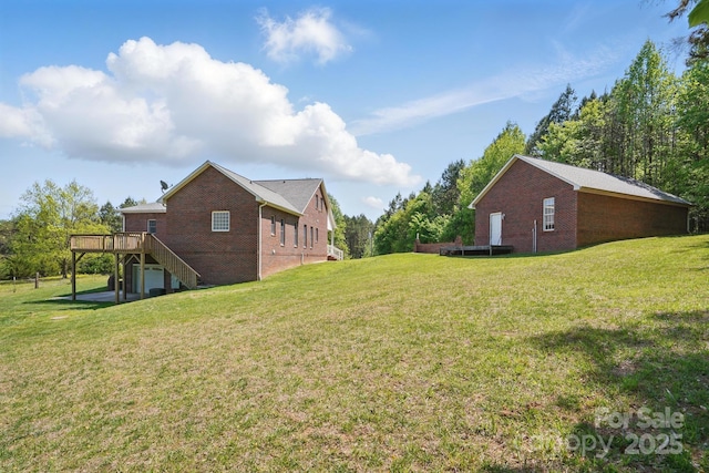 view of yard featuring a wooden deck and stairway