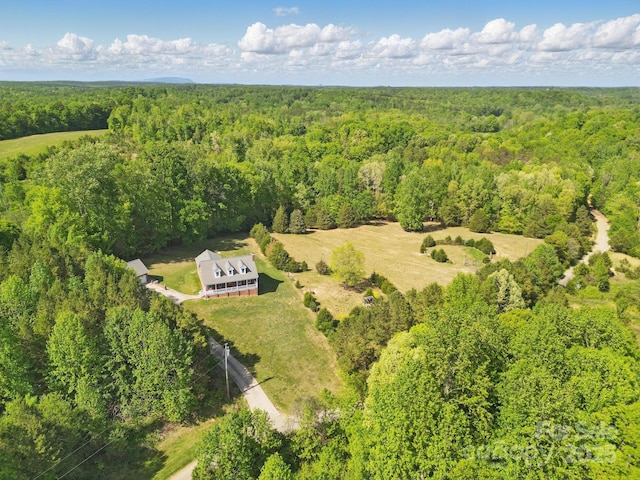 drone / aerial view featuring a wooded view