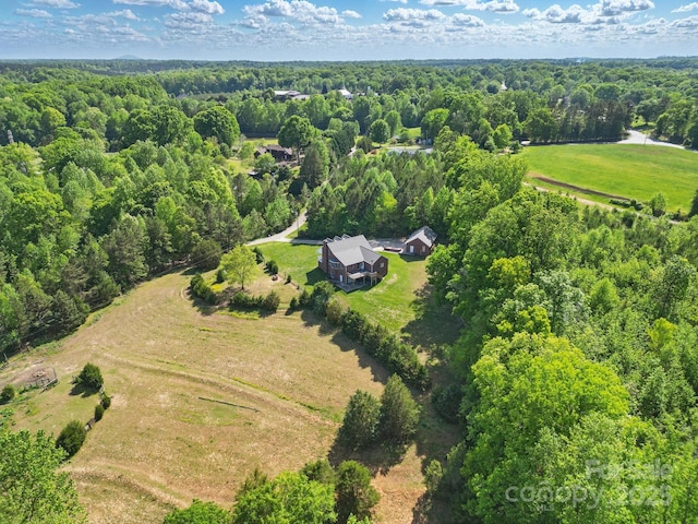 birds eye view of property with a wooded view