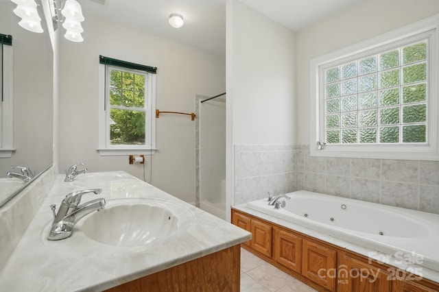 bathroom featuring a wealth of natural light, tile patterned floors, and a sink