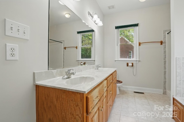 bathroom with double vanity, visible vents, and a sink