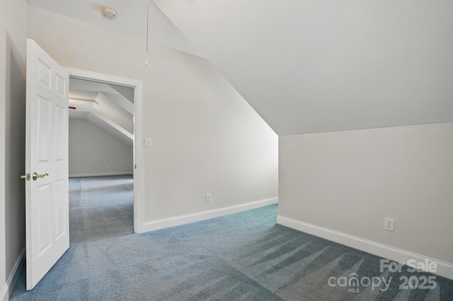bonus room featuring lofted ceiling, baseboards, and carpet