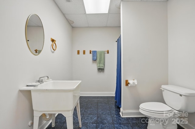 full bath with tile patterned flooring, a drop ceiling, toilet, baseboards, and a shower with shower curtain
