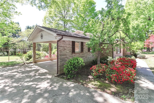 783 Carpenter Ave, Mooresville, NC 28115 - view of property exterior with driveway, brick siding, and a carport
