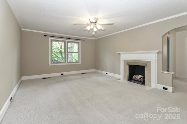 783 Carpenter Ave, Mooresville, NC 28115 - unfurnished living room with carpet, arched walkways, a ceiling fan, a premium fireplace, and ornamental molding