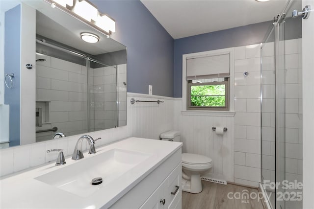 783 Carpenter Ave, Mooresville, NC 28115 - full bath with toilet, vanity, a tile shower, wood finished floors, and wainscoting