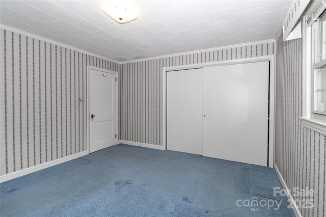 783 Carpenter Ave, Mooresville, NC 28115 - unfurnished bedroom with ornamental molding, wallpapered walls, carpet floors, and a closet