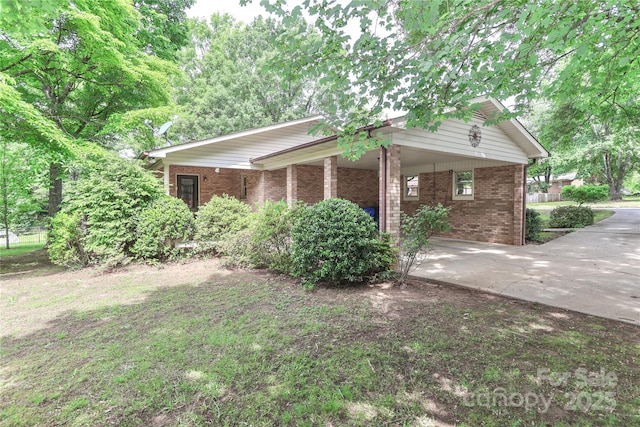 783 Carpenter Ave, Mooresville, NC 28115 - view of side of home with brick siding, an attached carport, and concrete driveway