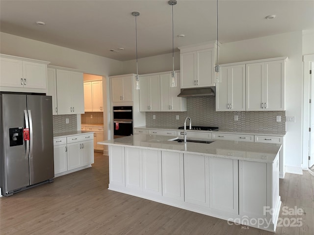 kitchen featuring stainless steel fridge with ice dispenser, white cabinets, a sink, and under cabinet range hood