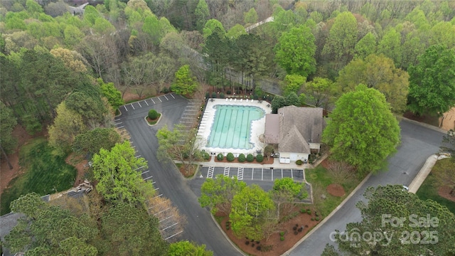 birds eye view of property with a wooded view