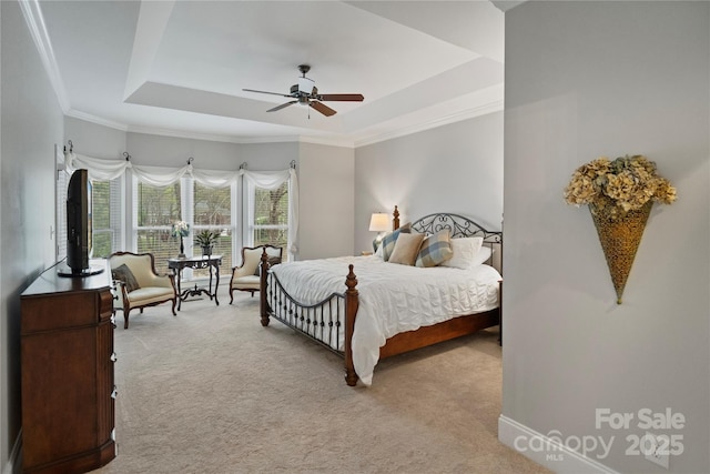 bedroom with light colored carpet, crown molding, a ceiling fan, and a raised ceiling
