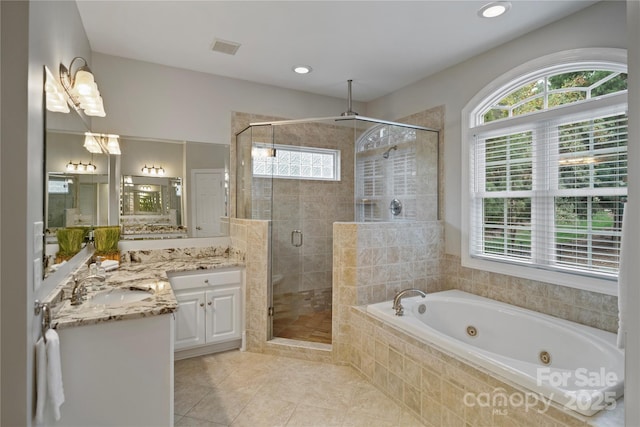bathroom featuring tile patterned flooring, vanity, a shower stall, a jetted tub, and visible vents