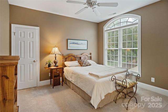 bedroom with baseboards, visible vents, carpet, and a ceiling fan