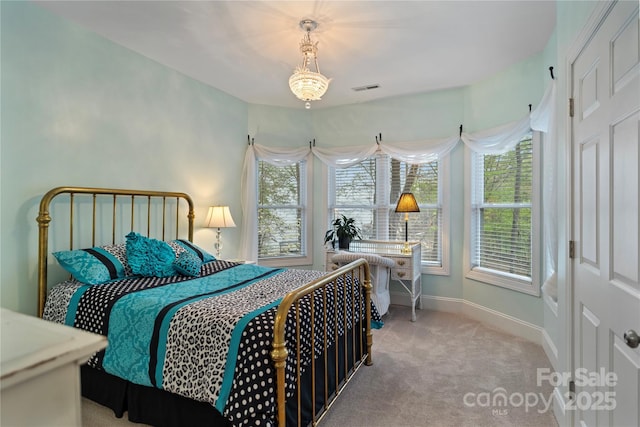 carpeted bedroom featuring baseboards and visible vents