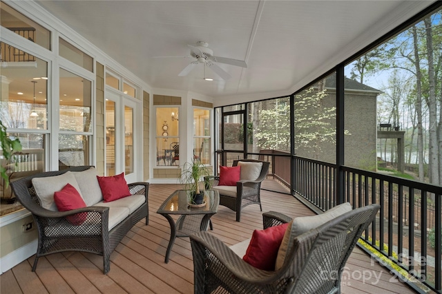 sunroom / solarium with an outdoor living space, ceiling fan, and a healthy amount of sunlight